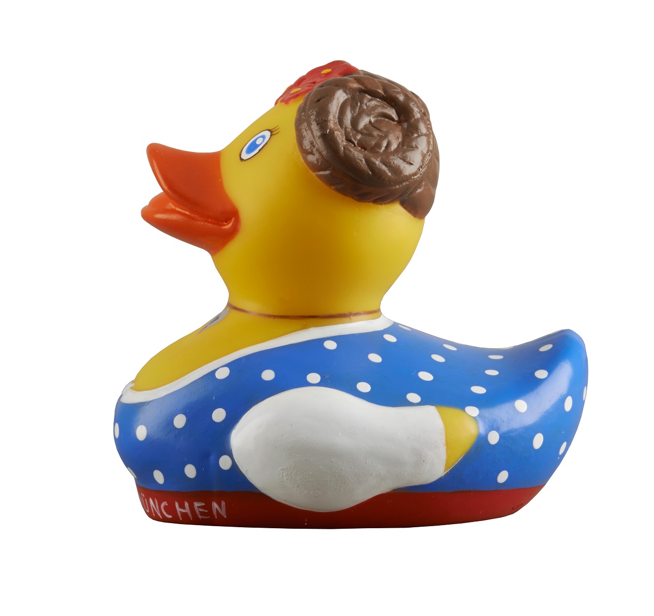 Gelbe Badeente im Dirndl, seitlich von links fotografiert. Die Ente trägt ein blau-weiß gepunktetes Kleid, hat braune, geflochtene Haarzöpfe und rote Blumen im Haar.